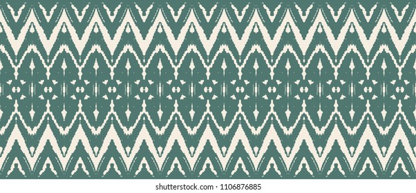 Ikat seamless pattern. Vector tie dye shibori print with stripes and chevron. Ink textured japanese background. Ethnic fabric vector. Bohemian fashion. Endless watercolor texture. African rug.