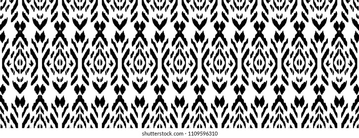 Ikat seamless pattern. Vector tie dye shibori print with stripes and chevron. Ink textured japanese background. Ethnic fabric vector. Bohemian fashion. Endless watercolor texture. African rug.