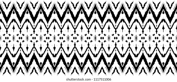 Ikat seamless pattern. Vector tie dye shibori print with stripes and chevron. Ink textured japanese background. Ethnic fabric vector. Bohemian fashion. Endless watercolor texture. African rug.