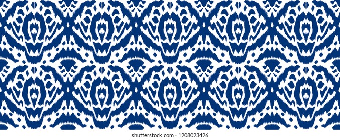 Ikat seamless pattern. Vector tie dye shibori print with stripes and chevron. Ink textured japanese background. Ethnic fabric vector. Bohemian fashion. Endless watercolor texture. African rug.