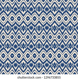 Ikat seamless pattern. Vector tie dye shibori print with stripes and chevron. Ink textured japanese background. Ethnic fabric vector. Bohemian fashion. Endless watercolor texture. African rug.