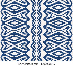 Ikat seamless pattern. Vector tie dye shibori print with stripes and chevron. Ink textured japanese background. Ethnic fabric vector. Bohemian fashion. Endless watercolor texture. African rug.