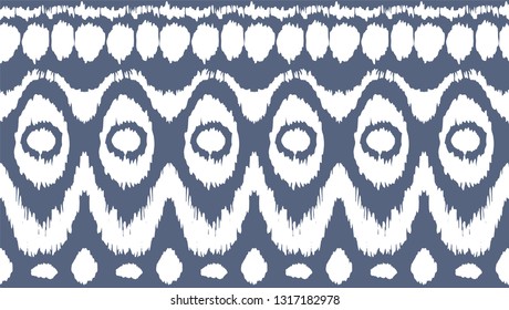 Ikat seamless pattern. Vector tie dye shibori print with stripes and chevron. Ink textured japanese background. Ethnic fabric vector. Bohemian fashion. Endless watercolor texture. African rug.