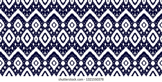 Ikat seamless pattern. Vector tie dye shibori print with stripes and chevron. Ink textured japanese background. Ethnic fabric vector. Bohemian fashion. Endless watercolor texture. African rug.