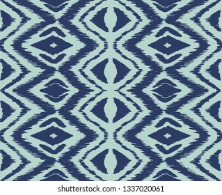 Ikat seamless pattern. Vector tie dye shibori print with stripes and chevron. Ink textured japanese background. Ethnic fabric vector. Bohemian fashion. Endless watercolor texture. African rug.