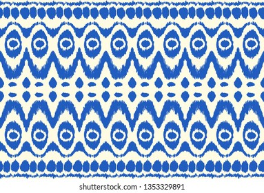 Ikat seamless pattern. Vector tie dye shibori print with stripes and chevron. Ink textured japanese background. Ethnic fabric vector. Bohemian fashion. Endless watercolor texture. African rug.