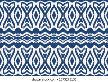Ikat seamless pattern. Vector tie dye shibori print with stripes and chevron. Ink textured japanese background. Ethnic fabric vector. Bohemian fashion. Endless watercolor texture. African rug.