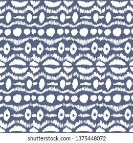 Ikat seamless pattern. Vector tie dye shibori print with stripes and chevron. Ink textured japanese background. Ethnic fabric vector. Bohemian fashion. Endless watercolor texture. African rug.