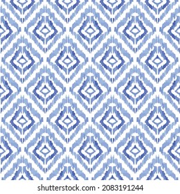Ikat seamless vector pattern. Ikat geometric ornament with blue color diamonds. 