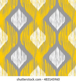 Patrón inquebrantable de ikat amarillo, blanco y gris. Antecedentes étnicos para el diseño textil, web e impreso