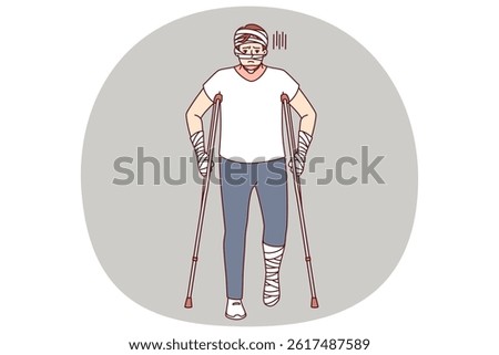 Ill man with bandages on hands and head uses walking aids after being involved in car accident. Guy injured in car accident needs long-term treatment and rehabilitation to restore health