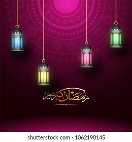 Illuminated hanging lanterns with golden arabic calligraphy  text Ramadan Kareem on magenta color background. 