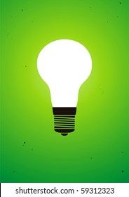Illuminated light bulb on green background