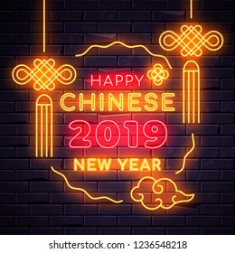 Illuminated neon signs chinese holiday light electric banner glowing on black brickwall background, happy new year text concept with oriental asian elements. Neons sign 2019 billboard design template
