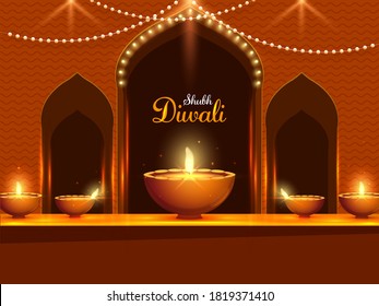 Illuminated Oil Lamps (Diya) and Lighting Garland Decorated Brown Door for Shubh (Happy) Diwali Celebration.