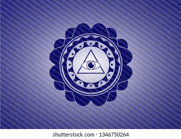 illuminati pyramid icon inside badge with denim texture