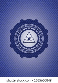 illuminati pyramid icon inside badge with denim texture