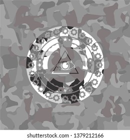 illuminati pyramid icon inside grey camouflage emblem