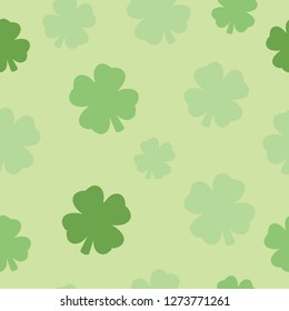 Illustrated seamless pattern four leaf clover design with a green background. 