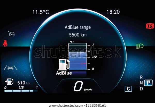 Illustration of AdBlue level indicator on\
illuminated car dashboard. Car instrument panel with speedometer,\
fuel gauge, seat belt reminder Urea level display on car cluster.\
Check diesel exhaust\
fluid