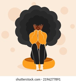 An illustration of an african american young woman sitting on a pillow. The woman has curly hair and wearing a yellow sweater, black jeans and light socks. Lady has her hands on face