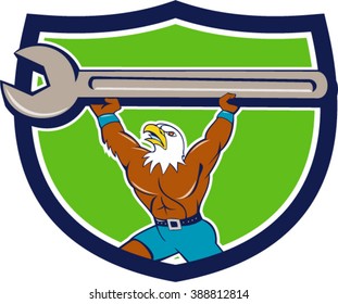 Illustration of a american bald eagle mechanic lifting giant spanner looking up to the side set inside shield crest on isolated background done in cartoon style. 