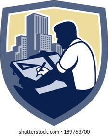 Illustration of an architect draftsman holding pencil and t-square drawing viewed from side set inside shield crest shape with buildings on isolated background done in retro woodcut style.