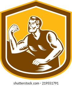 Illustration of an arm wrestling champion flexing muscles viewed from front set inside shield on isolated background done in retro woodcut style.