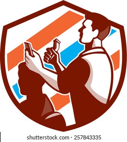 Illustration of a barber holding scissors and comb cutting hair facing side set inside shield crest done with barber pole color in the background done in retro style. 