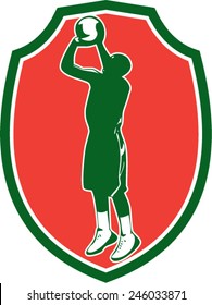 Illustration of a basketball player jump shot jumper shooting jumping set inside shield crest on isolated background done in retro style. 