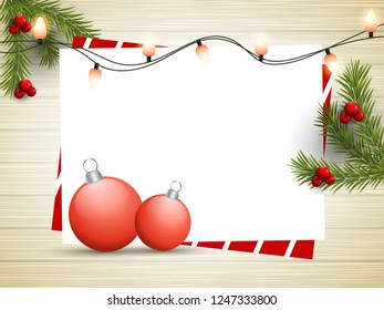 Illustration of baubles with pine leaves and blank greeting card on wooden texture background with space for your text.