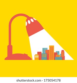 Illustration: a big city under the light of a desk lamp