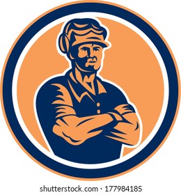 Illustration of a builder construction worker wearing hardhat with arms crossed facing front set inside circle done in retro style on isolated background.