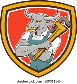 Illustration of a bull plumber standing with arms folded looking to the side holding monkey wrench set inside shield crest on isolated background done in cartoon style. 