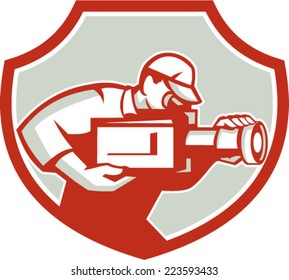 Illustration of a cameraman film crew shooting looking down on lens of video movie camera viewed from the side set inside shield crest done in retro style on isolated background. 