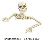 An illustration of a cartoon Halloween skeleton pointing down at a sign or scroll