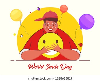 Illustration of Cheerful Young Man Holding a Emoji with Balloons and Yellow and White Background for World Smile Day.