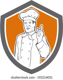 illustration of a chef, cook or baker with hand pointing up viewed from front set inside shield done in retro style on isolated background.