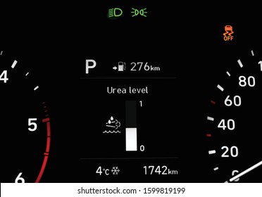 Illustration of close up of urea level indicator on car dashboard located between speedometer and tachometer. Car instrument panel with traction control warning light, low beam, side light indicators.