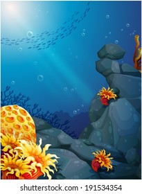 Illustration of the corals near the rocks and the school of fish