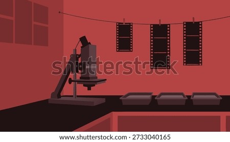 An illustration of a darkroom setup, featuring an enlarger on a table and film strips hanging to dry, bathed in a red light.