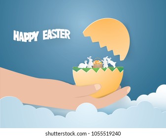 Illustration of Easter day .Eggs in basket on grass surrounded by family rabbit  in hand on the sky background  ,paper craft style