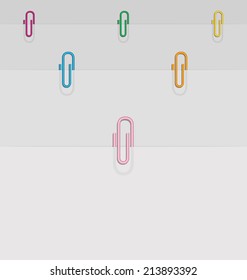 illustration of four sheets of paper and colored paper clips 