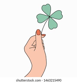 Illustration of hand holding Clover leaf.