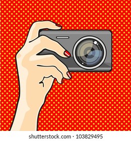 Illustration of a hand holding a photo camera