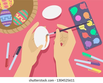 Illustration of Hands Holding a Paintbrush Painting a White Egg for Easter with Paint, Colored Pens and Decorative Eggs on Desk