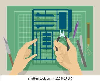 Illustration Of Hands Holding A Plastic Model And A Cutter