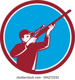 Illustration of a hunter wearing hat aiming shooting up shotgun rifle viewed from the side set inside circle on isolated background done in retro style. 