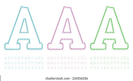 illustration of a letter and number created with pushpin green, blue and pink 
