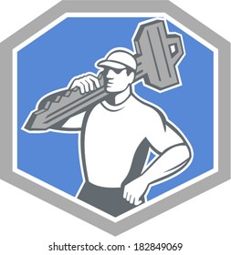 Illustration of a locksmith standing front side view carrying key on shoulder set inside shield  crest on isolated background done in retro style